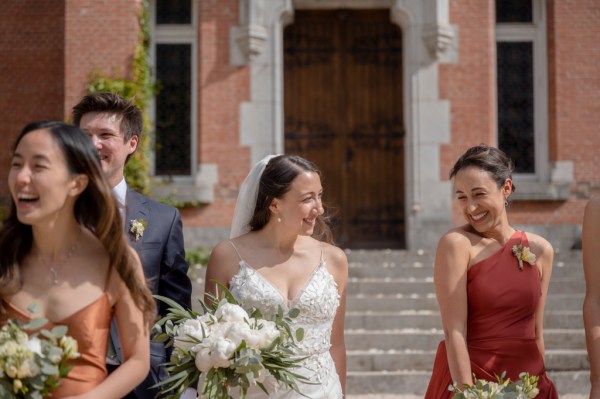 Bride bridesmaids smile and walk in the sunshine